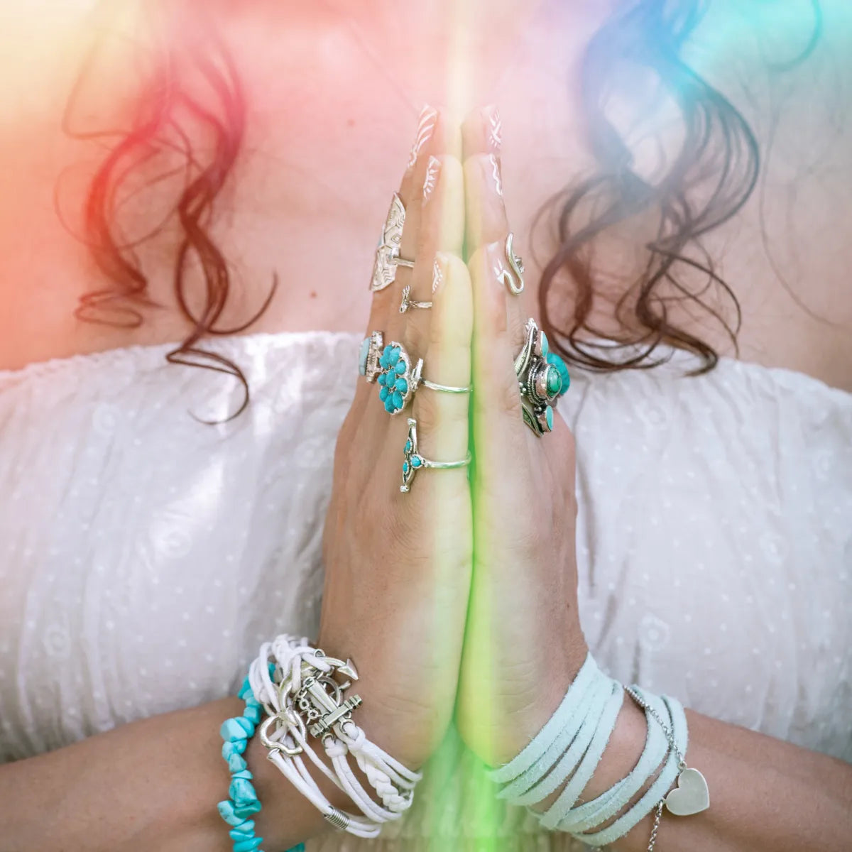 Hands in prayer position (Anjali Mudra) with light glow, Blissful Light Reiki attunements.